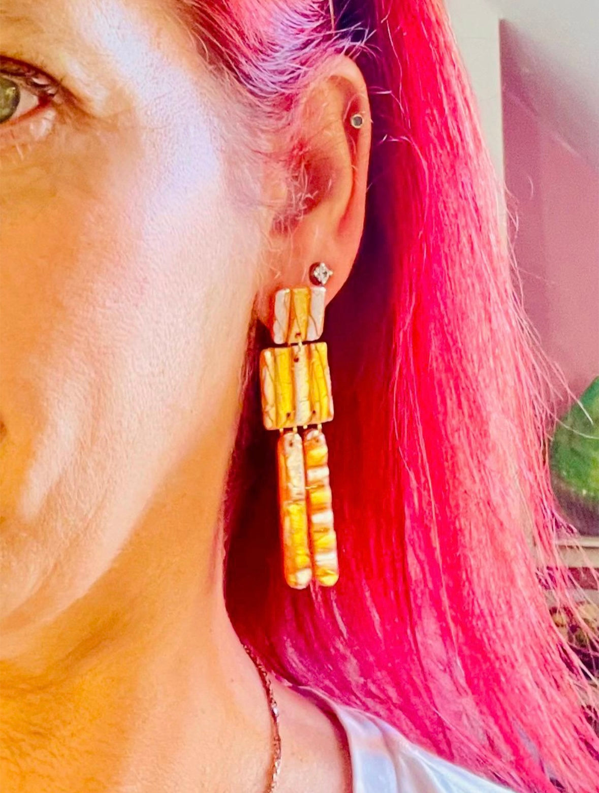 These striking earrings are a true statement piece to express summer fun. Featuring a mix of orange, gold, and silver, they add an opulent touch to elevate any outfit. Wear them under the sun and enjoys the shimmering sparkles created with each move.

These earrings are totally handmade by me and each piece is slightly different.
MySaraJewellery
