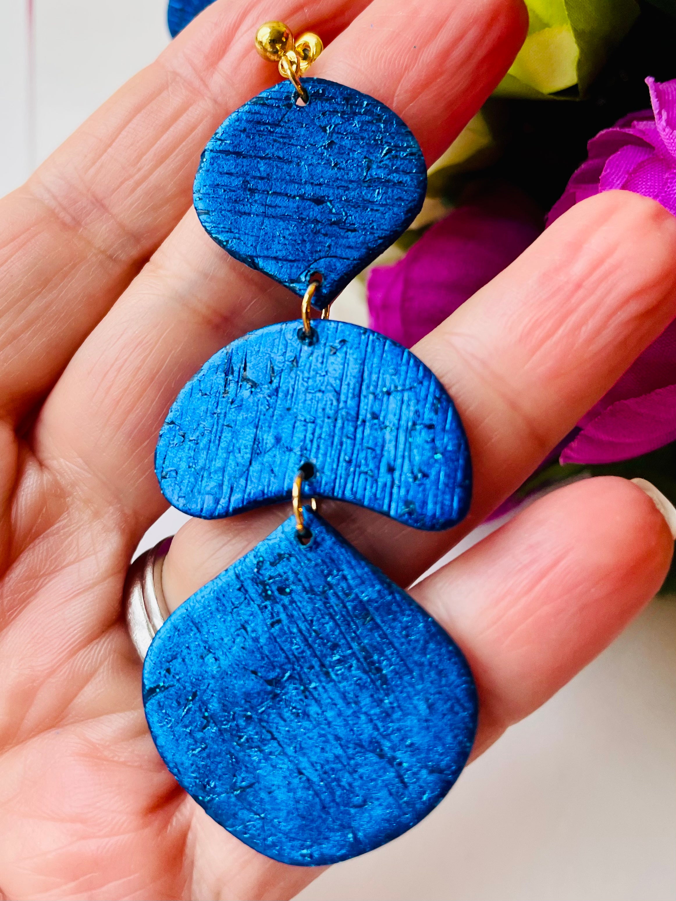 Make a statement with these unique handmade earrings. Exceptional craftsmanship and royal blue color make them the perfect accessory for a special event or just to elevate your everyday look.These unique royal blue earrings are made from polymer clay covered in foil and they have a light stripy texture. The posts are made of stainless steel and come with plastic backs instead of metal butterfly.These stunning earrings measure approximately 3cm width x 7.5cm length and are very light.