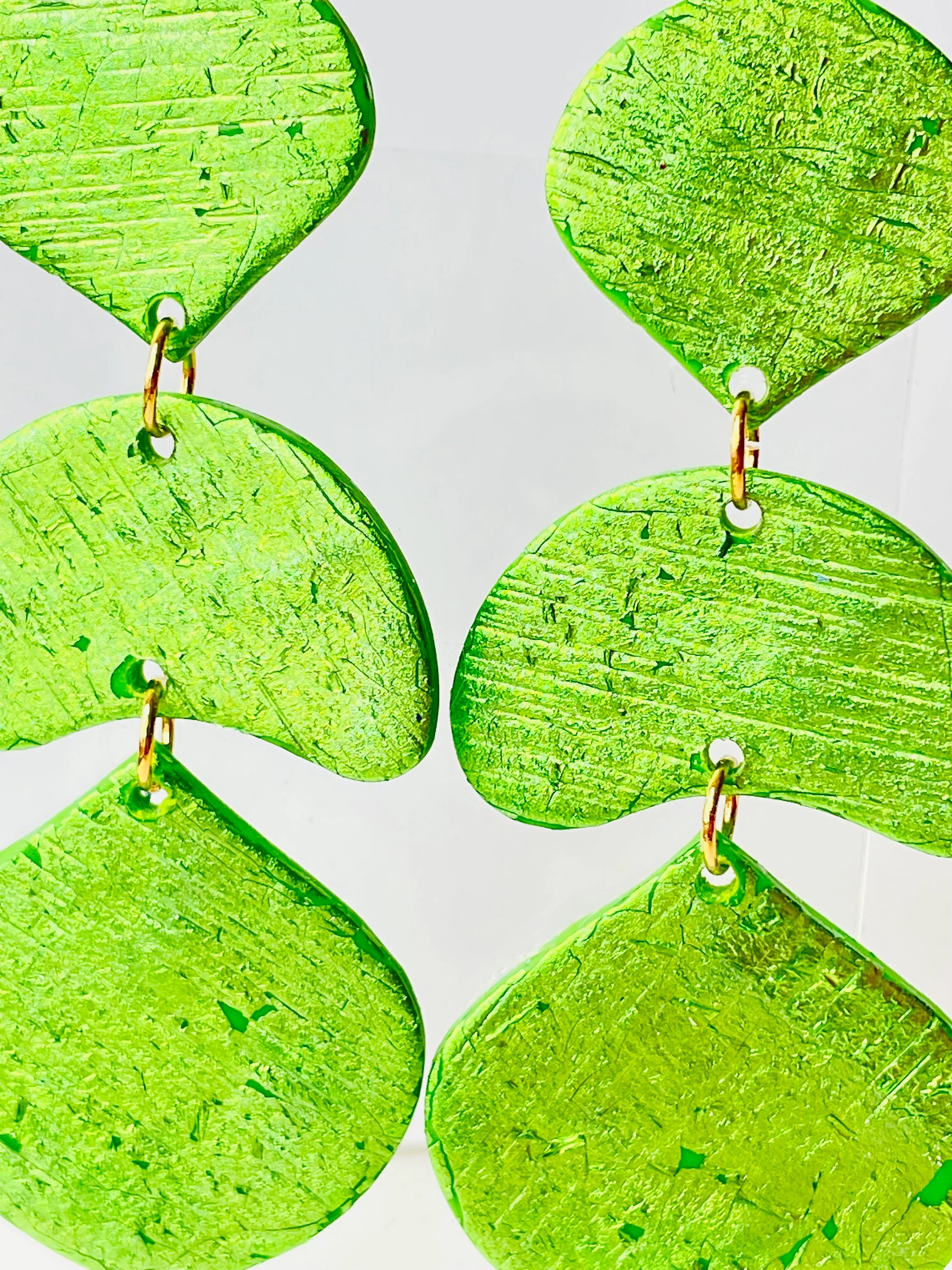 Make the most of the holiday season with these stunning statement earrings. Featuring a vibrant green color and unique texture, they're sure to turn heads at any party. And with their bold design, these earrings make the perfect gift for any fashion-forward friend or loved one. It is always the season for showing off your style! Add a vibrant green accent to your summer dresses on the beach or for an al fresco aperitif!
