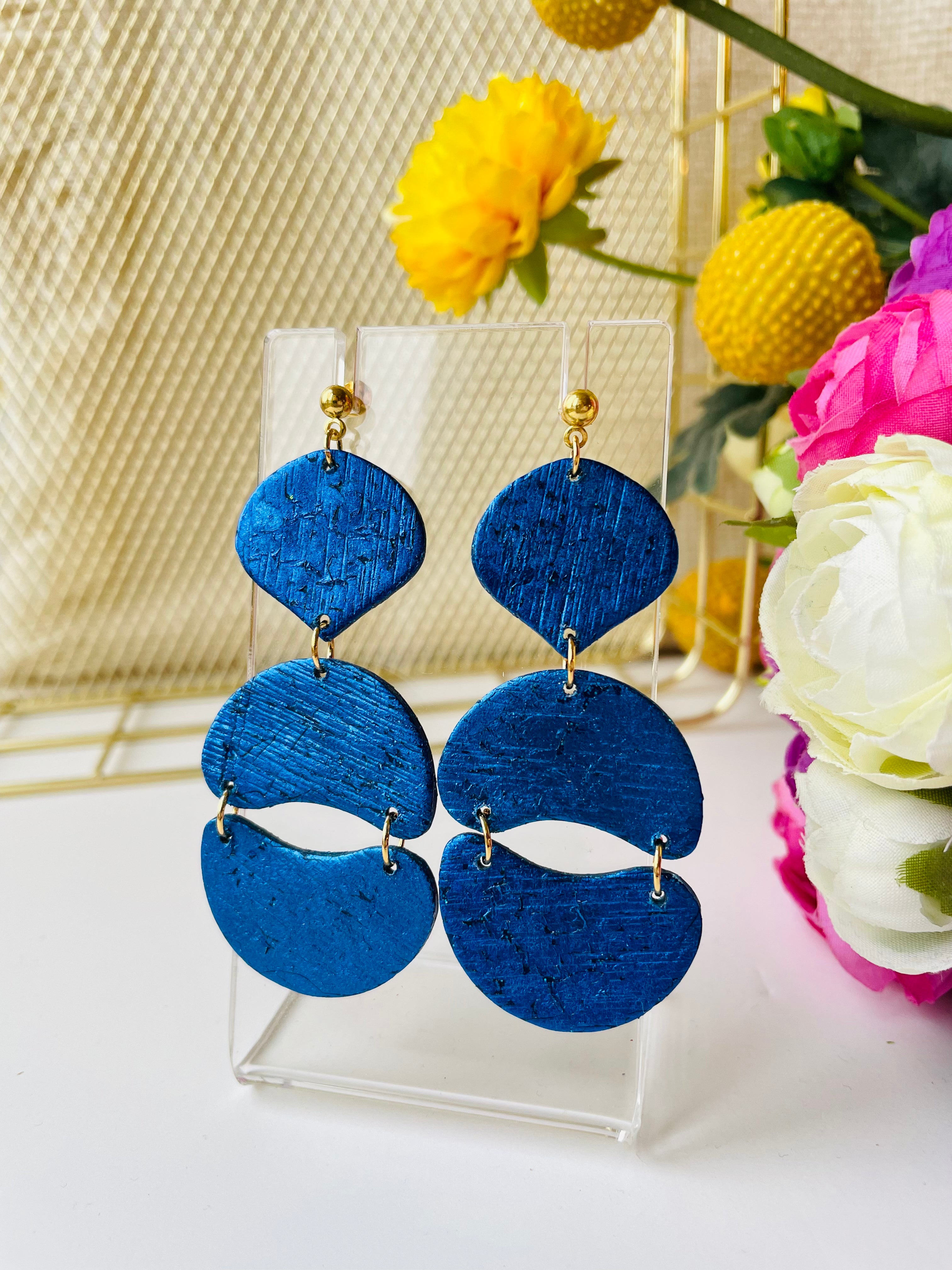 Make a statement with these unique handmade earrings. Exceptional craftsmanship and royal blue color make them the perfect accessory for a special event or just to elevate your everyday look.These unique royal blue earrings are made from polymer clay covered in foil and they have a light stripy texture. The posts are made of stainless steel and come with plastic backs instead of metal butterfly.These stunning earrings measure approximately 3cm width x 7.5cm length and are very light.