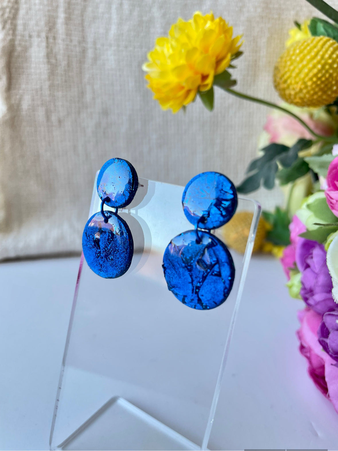 Crafted from vibrant blue polymer clay, these stunning earrings are named after the renowned Venetian island of Murano. Inspired by the island's colorful glass, these small earrings are available in a variety of bold shades, making them the perfect everyday accessory or thoughtful birthday gift.