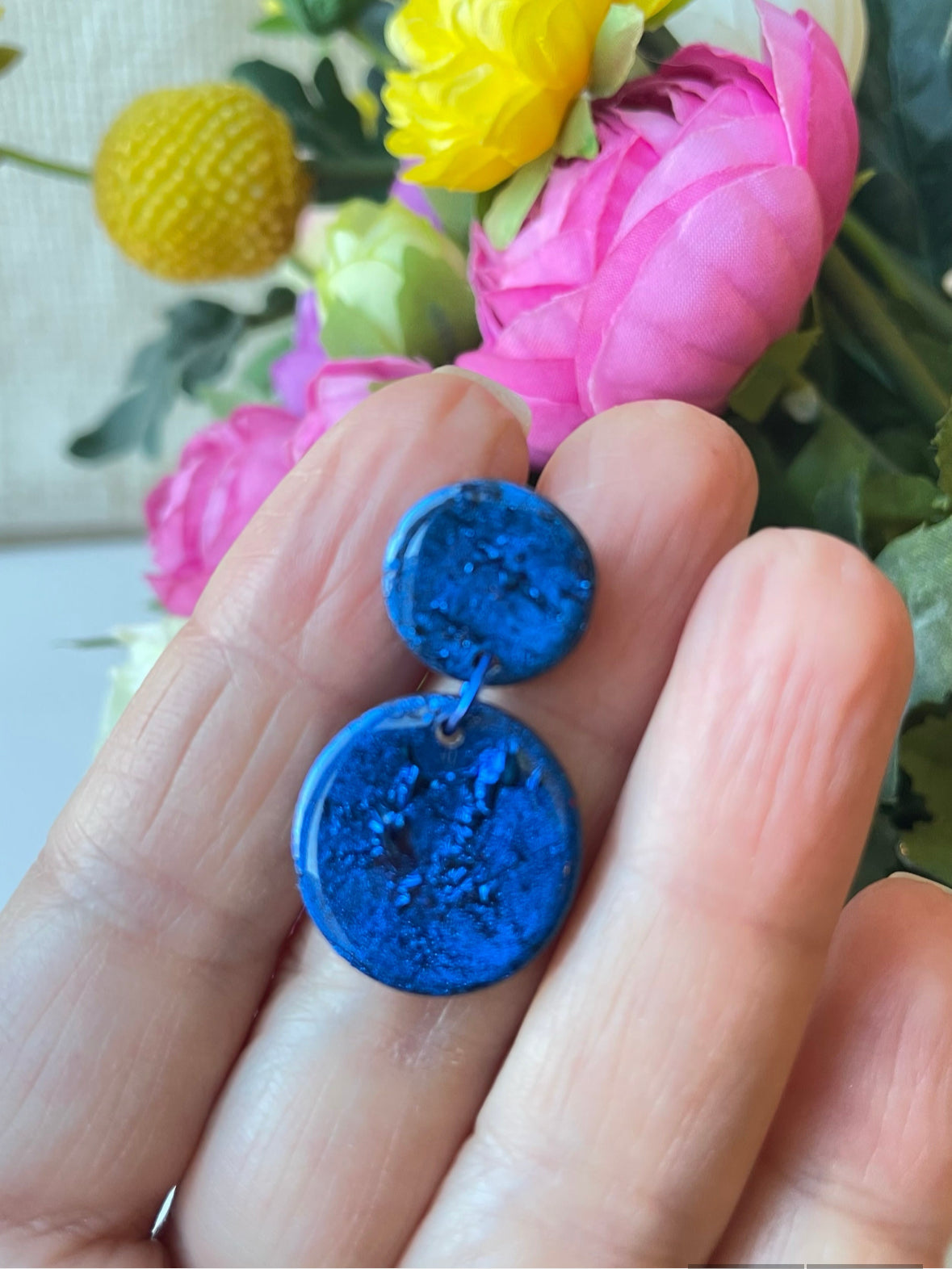 Crafted from vibrant blue polymer clay, these stunning earrings are named after the renowned Venetian island of Murano. Inspired by the island's colorful glass, these small earrings are available in a variety of bold shades, making them the perfect everyday accessory or thoughtful birthday gift.