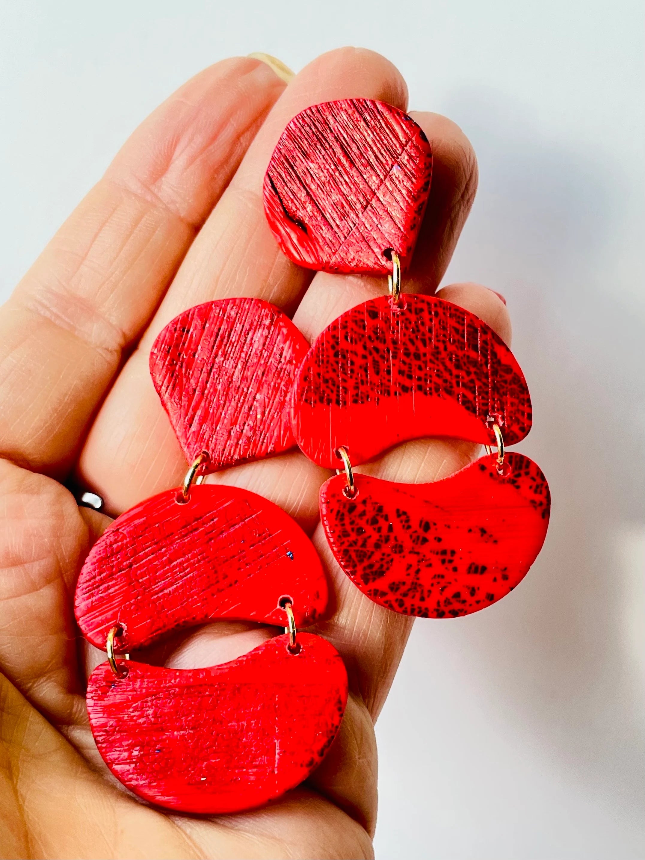 Enhance your appearance with our vibrant, bold statement earrings - an ideal choice for a birthday or special event gift. If you adore red, you will adore these red statement earrings! Handmade with polymer clay and red foil, these distinctive drop earrings feature a subtle striped texture that catches the light beautifully.
Stainless steel posts
3 cm width x 7 cm length
Lightweight
Handmade by me, each one is unique.
Custom colors available on request
Clip on backs available
