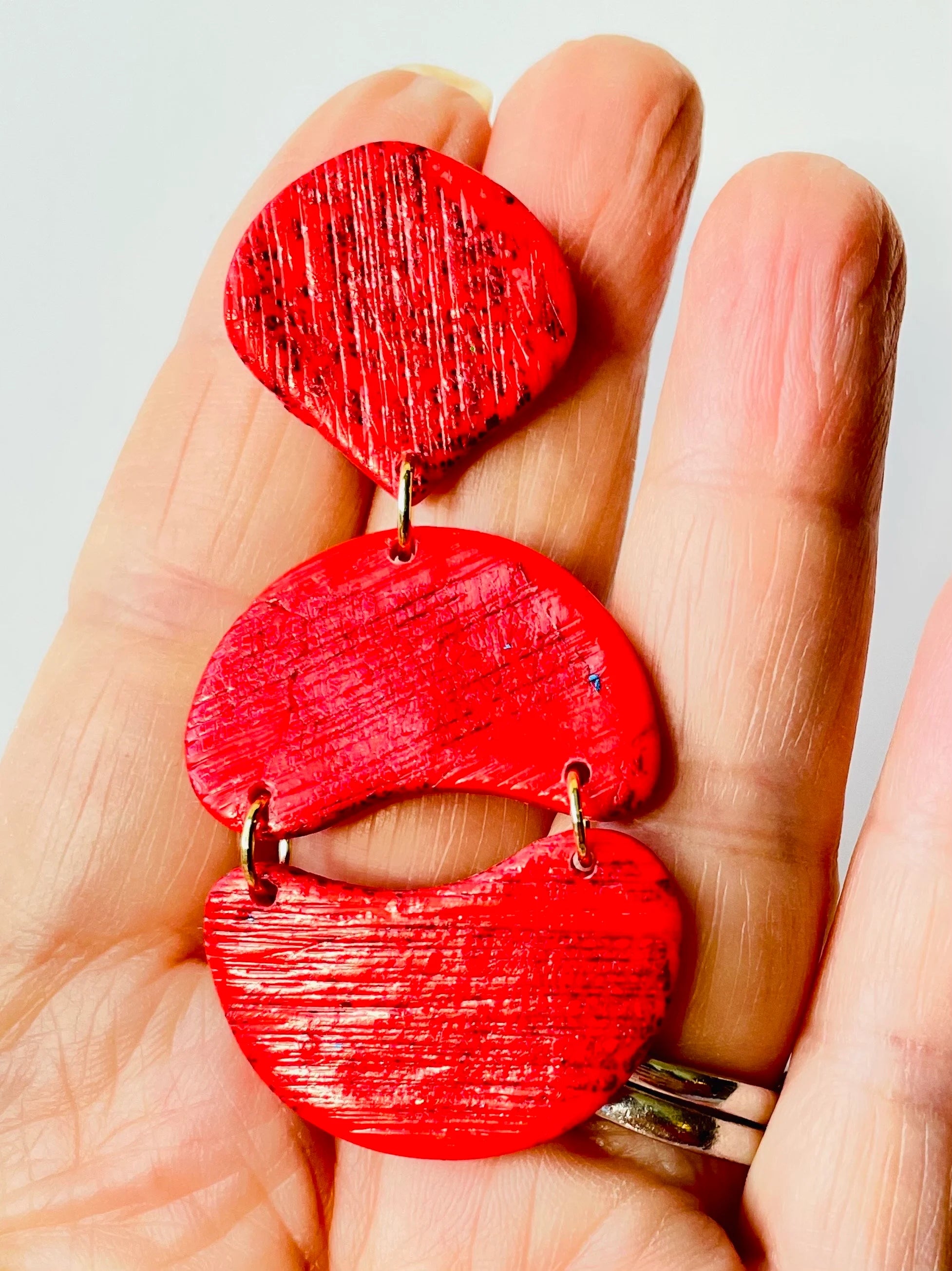 Enhance your appearance with our vibrant, bold statement earrings - an ideal choice for a birthday or special event gift. If you adore red, you will adore these red statement earrings! Handmade with polymer clay and red foil, these distinctive drop earrings feature a subtle striped texture that catches the light beautifully.
Stainless steel posts
3 cm width x 7 cm length
Lightweight
Handmade by me, each one is unique.
Custom colors available on request
Clip on backs available