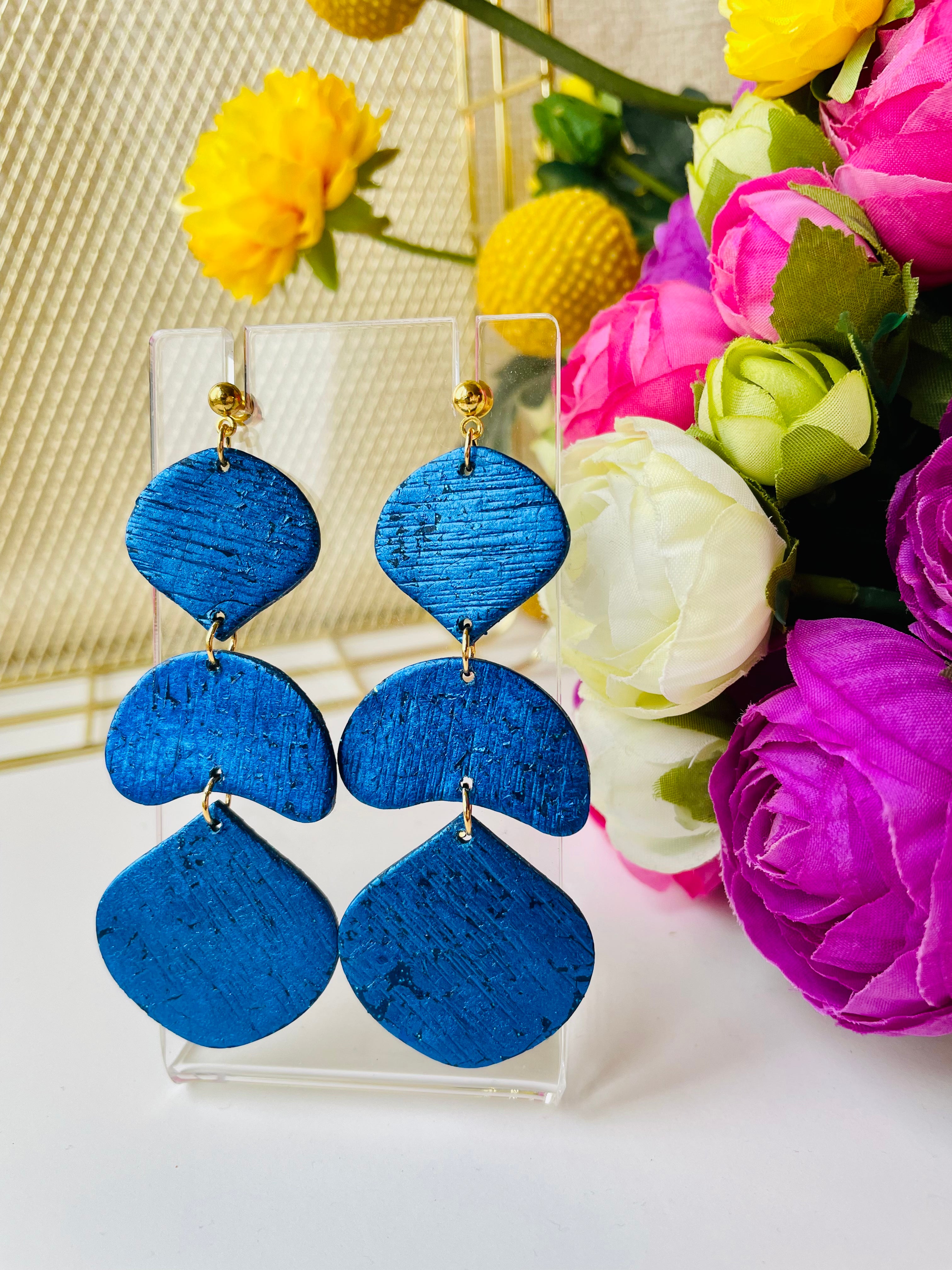 Make a statement with these unique handmade earrings. Exceptional craftsmanship and royal blue color make them the perfect accessory for a special event or just to elevate your everyday look.These unique royal blue earrings are made from polymer clay covered in foil and they have a light stripy texture. The posts are made of stainless steel and come with plastic backs instead of metal butterfly.These stunning earrings measure approximately 3cm width x 7.5cm length and are very light.
