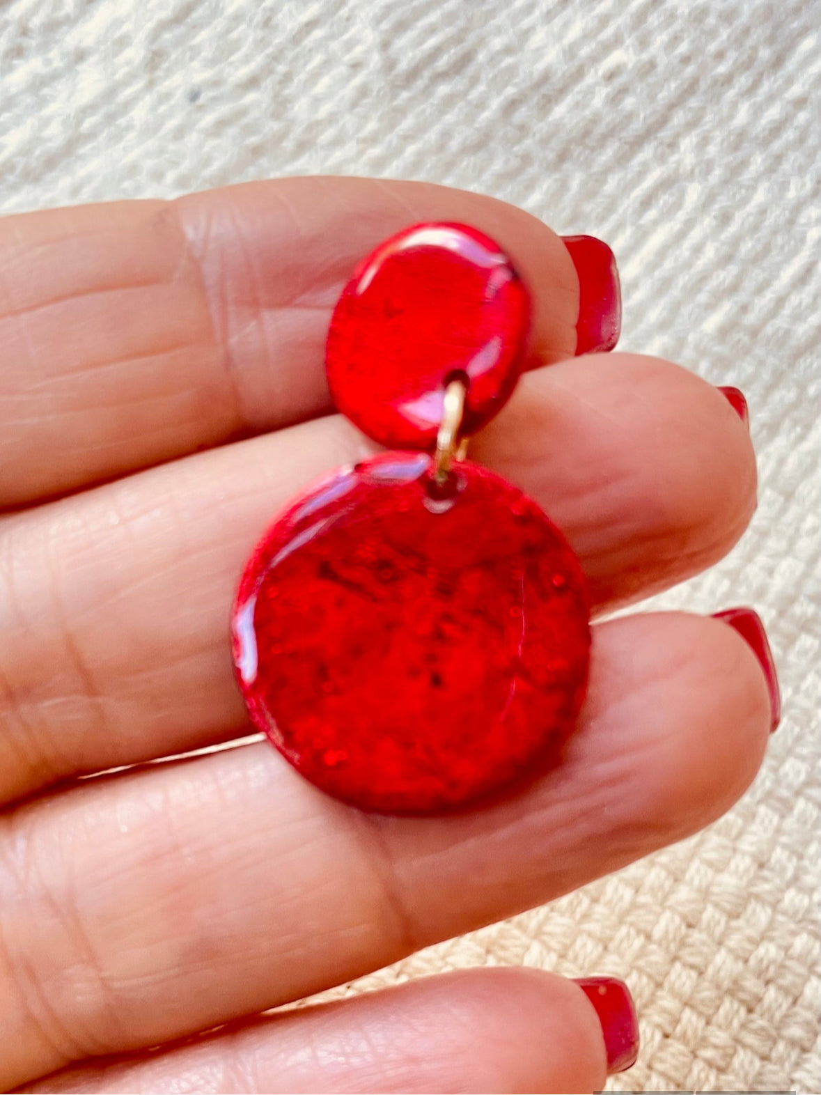 Dazzle with these funky red earrings that look like cracked glass! Crafted from lightweight polymer clay and coated in resin, they're perfect for making a bold fashion statement. Inspired by Murano glass beads, but way easier on the ears. ;)