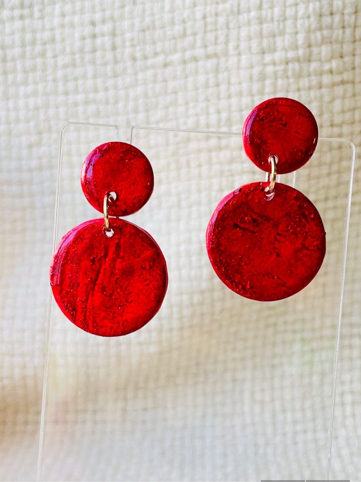 Dazzle with these funky red earrings that look like cracked glass! Crafted from lightweight polymer clay and coated in resin, they're perfect for making a bold fashion statement. Inspired by Murano glass beads, but way easier on the ears. ;)